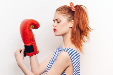 Woman in boxing red gloves on white background