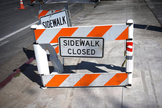 sidewalk closed sign barricade warning