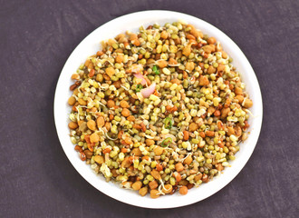 Germinated healthy seeds on the black background in white plate.