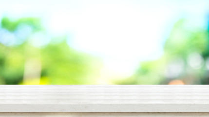 Empty white rustic wood table top with blur blue green tree boekh background,Mock up template for display or montage of product or content use as banner in social media ads