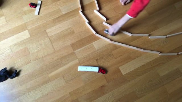 Children playing with toy cars. 90 degree angle of children playing with toys. Angle from above of kids playing with toys3