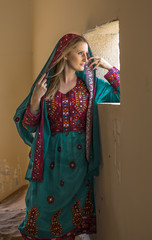 a woman in traditional Omani dress in a countryside of UAE