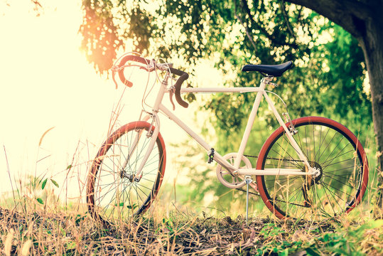 beautiful landscape image with sport vintagr Bicycle at sunset