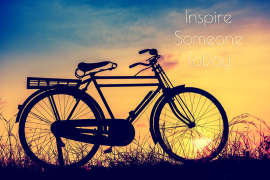 beautiful landscape image with Silhouette  Bicycle at sunset in vintage tone style