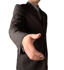 Businessman going to shake your hand on a white background