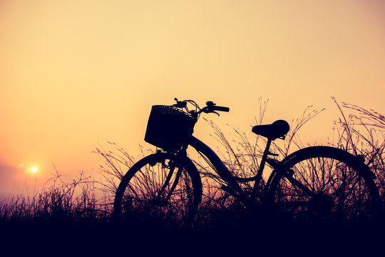 beautiful landscape image with Silhouette Bicycle at sunset © Looker_Studio
