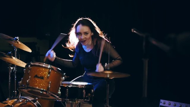Close up view of girl rock musician- female drummer, slow-motion