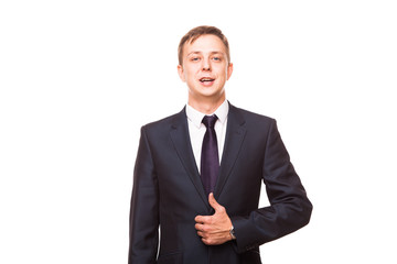 Young handsome businessman in black suit is standing straight, portrait isolated on white background