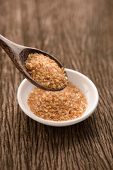 Raw Organic Cane Sugar in a wooden spoon