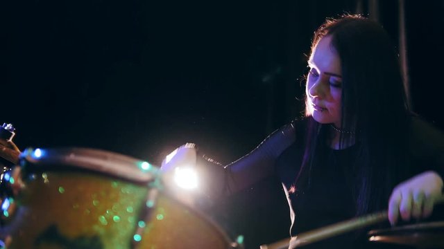 Beauty black hair girl twisting drumstick - drum performing, rock music