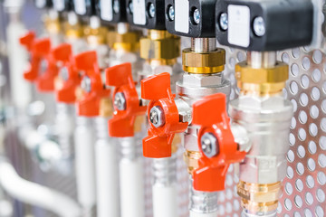 A lot of ball valves, arranged in a row.