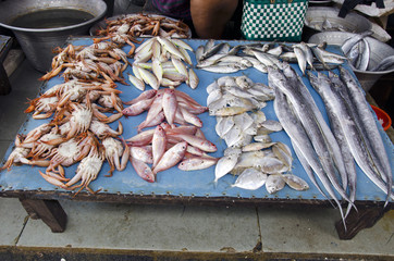 fresh fishes and crabs on indian market stall, South India