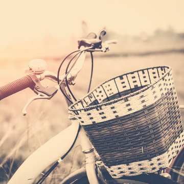 beautiful landscape image with Bicycle at sunset ; vintage filter style