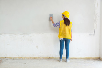 Female Worker, Labor Plastering White Concrete Wall at Home, House Construction Site