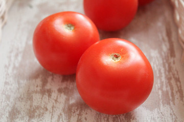 Tomato in white wickerwork handbasket