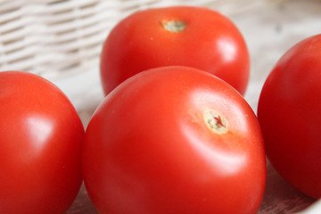 Tomato in white wickerwork handbasket