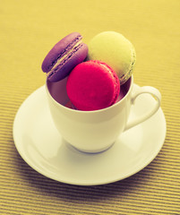 colorful macarons on Napery background,macarons in a cup