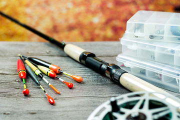 fishing rod with acsessories on the grey wooden table