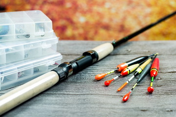 fishing rod with acsessories on the grey wooden table