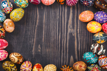 Easter eggs on dark wooden background.