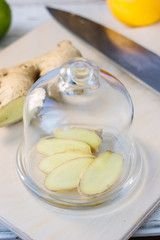Slices of ginger root covered by glass cover.