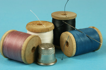 wooden spools with colored cotton threads for sewing, vintage