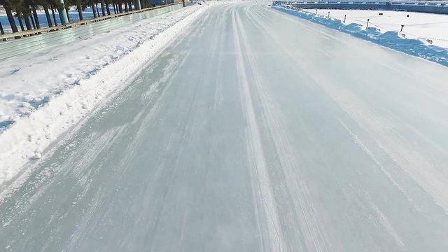 Speed ice skating outdoor race HD aerial video. Flying over professional track winter olympic