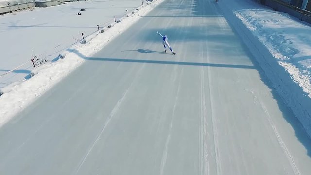 Speed ice skater skating on outdoor race HD video. Flying over professional athlete training for winter olympic