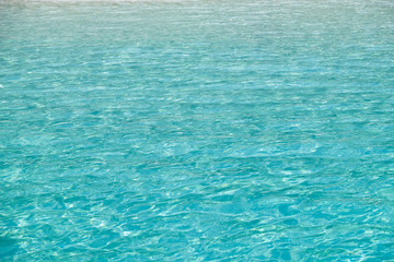 Blue sea wave ripple curl water surface texture. Summer holiday relax background with copy space.