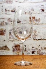 Empty wine glass against a rustic background