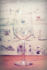Empty wine glass against a rustic background