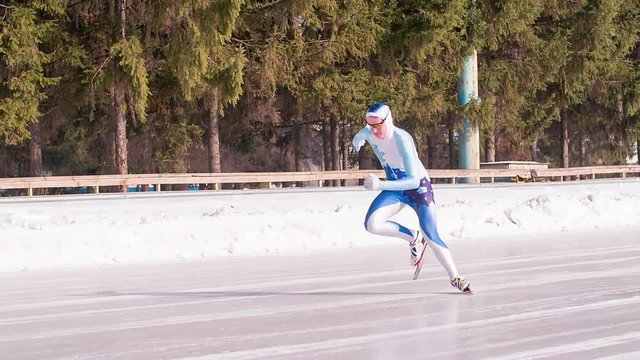 Speed ice skater skating on outdoor race on start HD slow-motion video. Professional athlete training for winter olympic