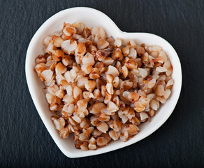 Buckwheat in a white plate, steamed, diet breakfast, food.