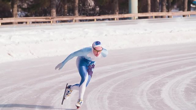 Speed ice skater skating on outdoor race on turn HD slow-motion video. Professional athlete training for winter olympic