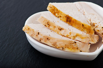 Chicken with spices on a white plate, healthy meal.