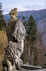 The lady and her lion made from stone, statues in a public park