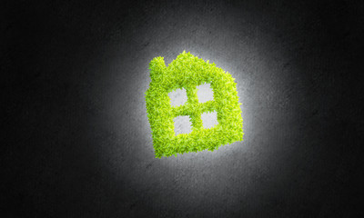 Concept of eco architecture presented by green house on dark background
