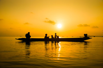 Naklejka na ściany i meble Silhouettes fisherman and family on the lake, Thailand.