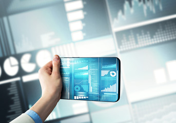 Media technology concept presented by businessman holding tablet with graphs and diagrams