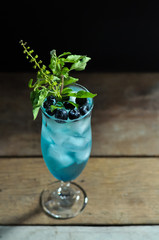 Idea for decoration refreshing cold cocktail with blueberry and hot basil