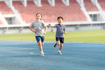 Boy running on the blue track