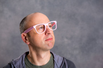 funny baldheaded man with pink glasses