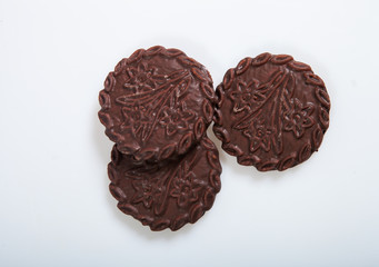 Cookies in chocolate glaze on a light background