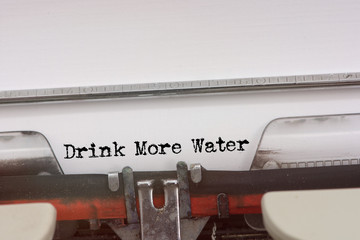  Drink More Water word typed on a Vintage Typewriter