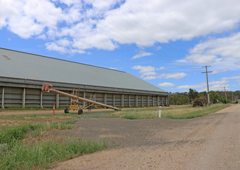 a grain storage shed and auger
