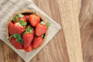 fresh strawberries in bowl on napkin on table, organic garden berries