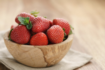 fresh strawberries in bowl on napkin on table, organic garden berries