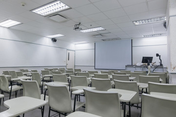 Fototapeta na wymiar Abstract blur school classroom interior with desk background