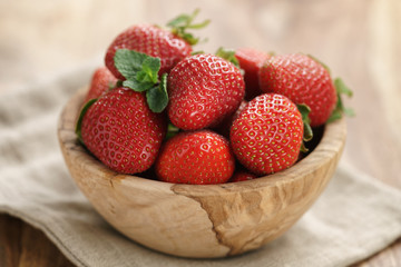 fresh strawberries in bowl on napkin on table, organic garden berries