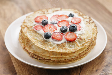 fresh blinis or crepes with fresh berries and cream, sweet food